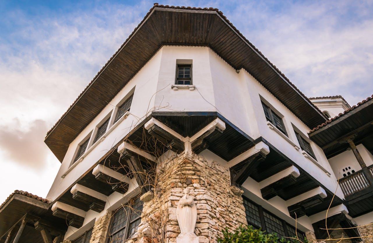 Low angle view of a historic building facade in Varna, Bulgaria against a clear blue sky.